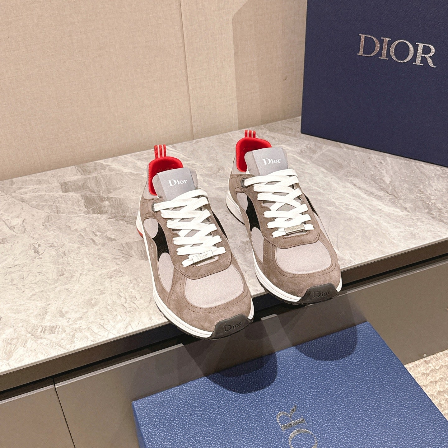 Dior unisex sneakers in beige and white suede with red heel accents and black side panels