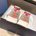 Dior unisex sneakers heel view with red-and-white strap accents and white branding on backs