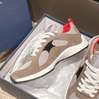 Dior unisex sneakers in a box with beige suede, black side panels, white laces, and red trim