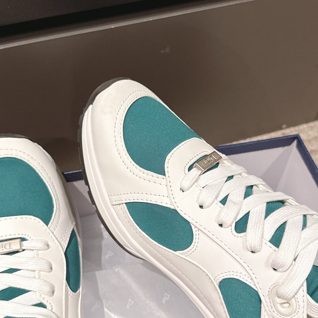 Unisex sneaker profile, white leather with teal oval insert and lace-up closure