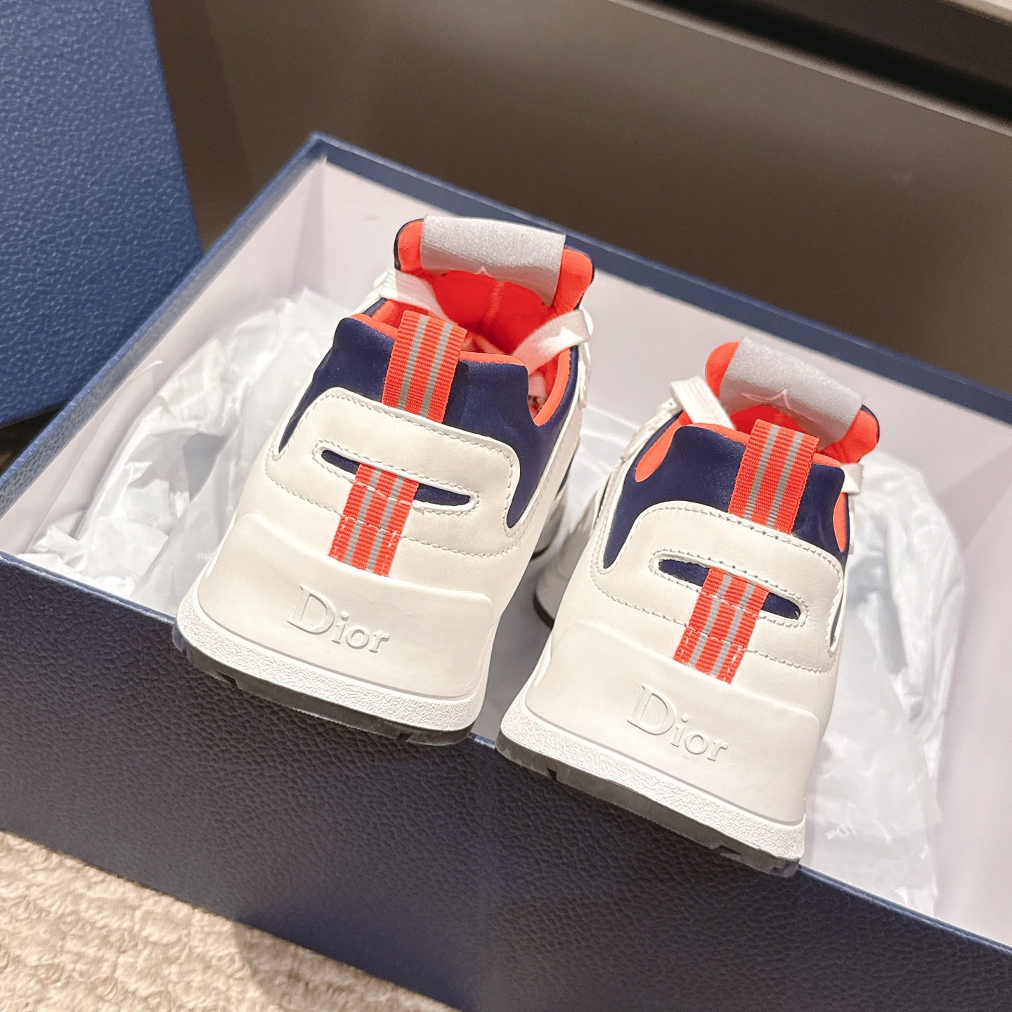 Dior unisex sneakers back view, white with navy and orange-red heel strap