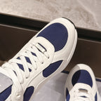 Dior unisex sneakers close-up, white leather with navy side panel and laces