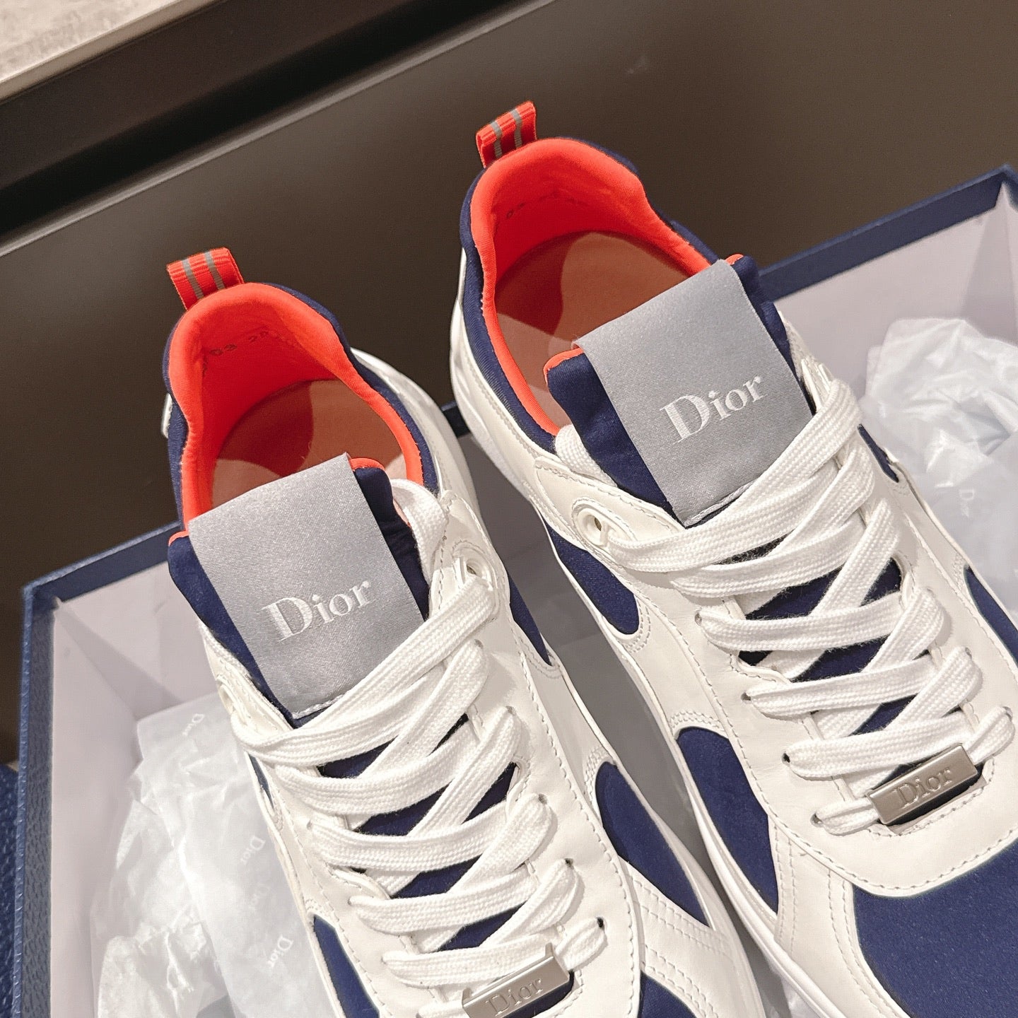 Dior unisex sneakers in box, white with navy trim and gray tongue with orange lining