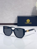 Dark blue sunglasses with rounded lenses and gold logo detail on temples