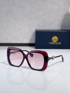 Versace sunglasses with dark maroon frames and pink-tinted lenses