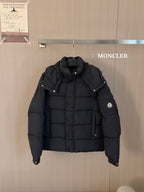 Black puffer jacket with hood, button front and Moncler logo patch on sleeve