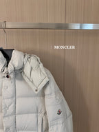 Moncler long white puffer jacket, side view with quilted sections and snap cuffs