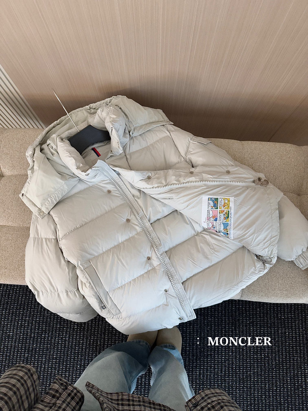 Moncler long white puffer jacket laid open, hood lining and zipper front visible