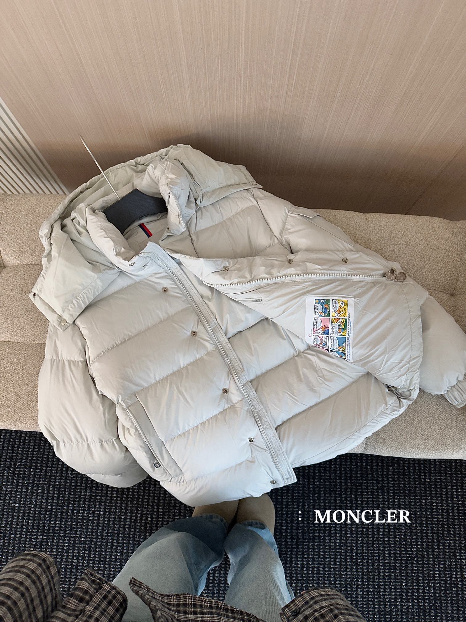 Moncler long white puffer jacket laid open, hood lining and zipper front visible