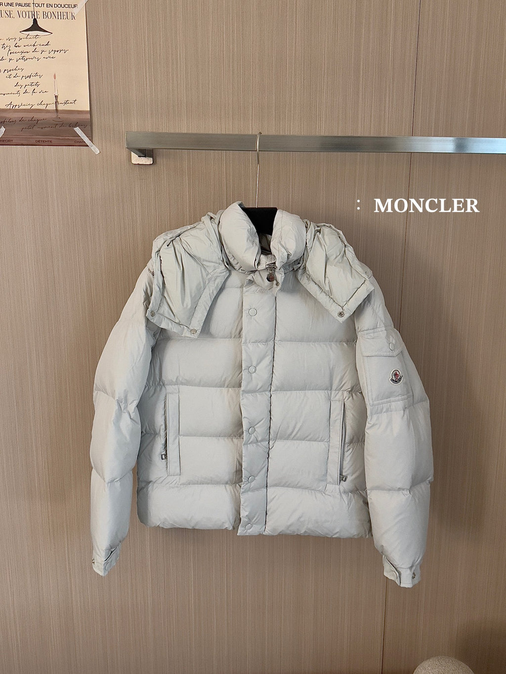 Moncler long white puffer jacket with hood, front snap buttons, and quilted panels