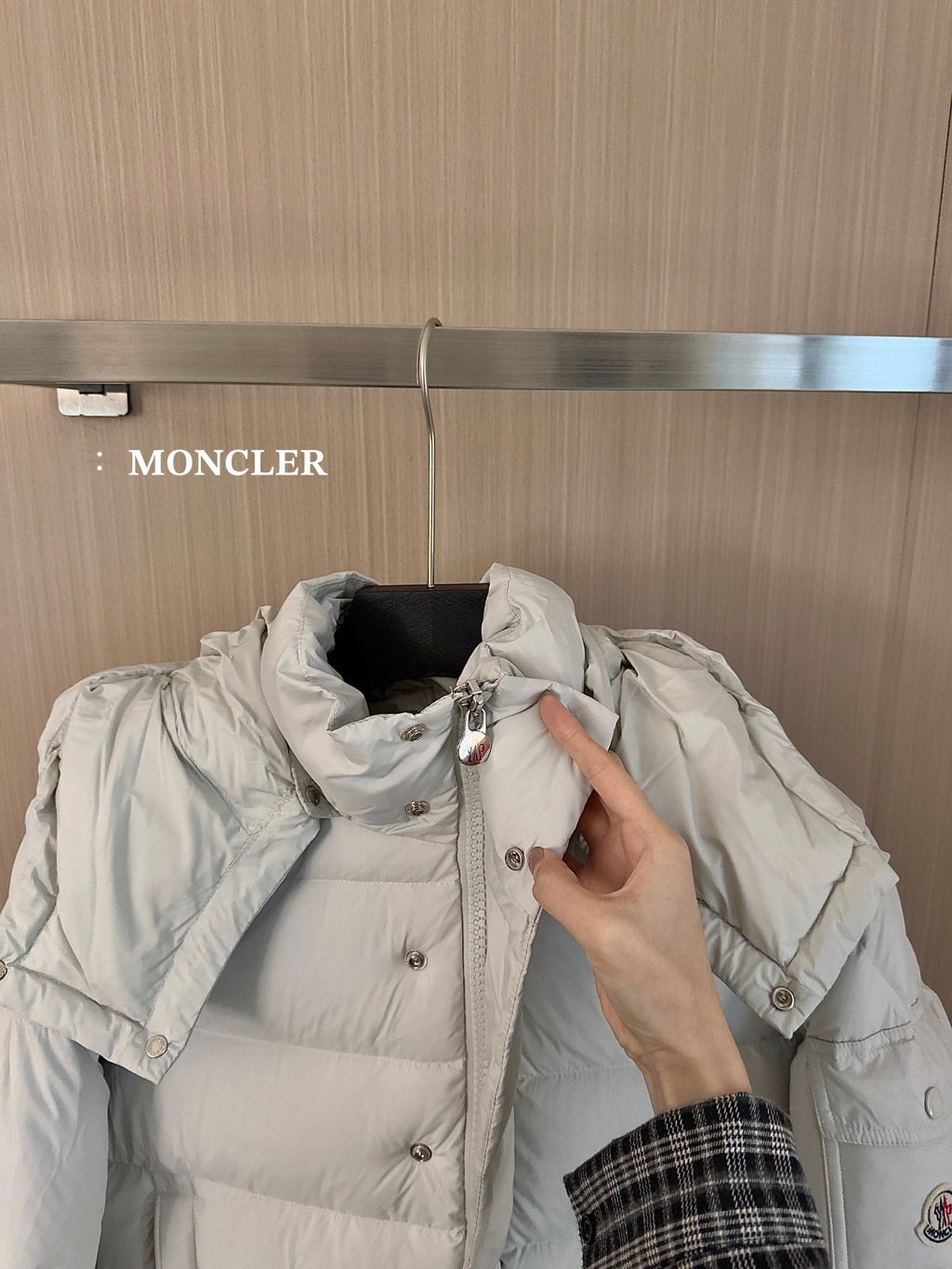 Moncler long white puffer jacket with hood, snap buttons, and raised collar detail