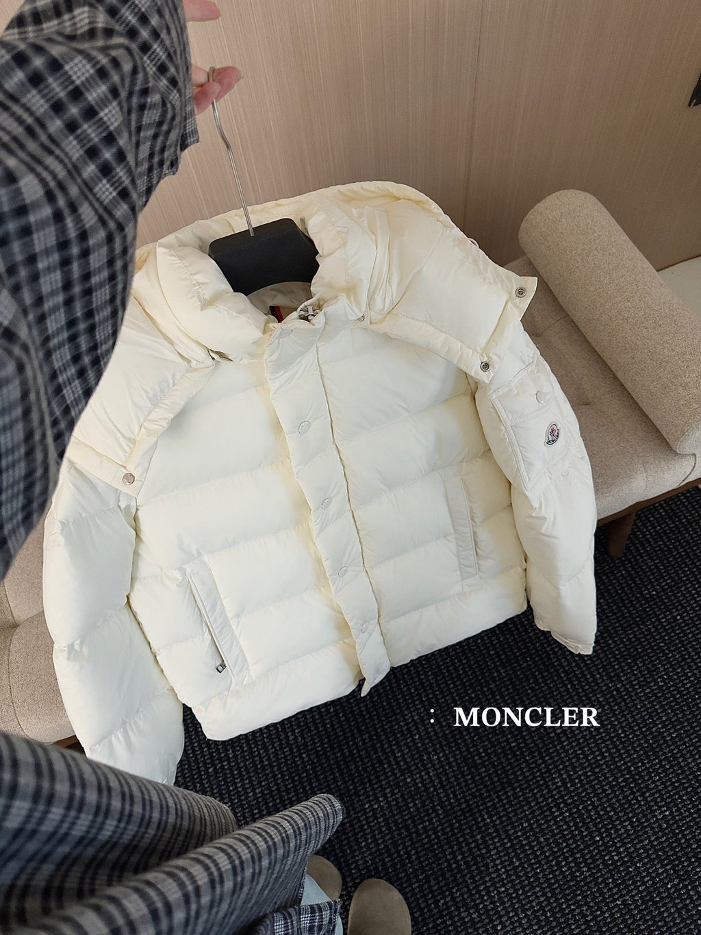 White long puffer jacket on bed, front view with hood and button placket
