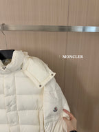 White long puffer jacket, side view with snap buttons and logo patch