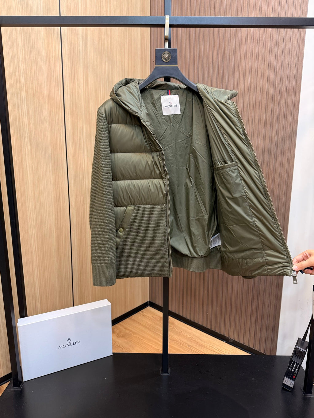 Long puffer jacket in dark olive green, open front with hood lining visible