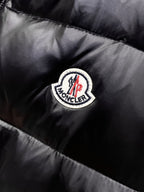Moncler round logo patch on black quilted puffer vest fabric