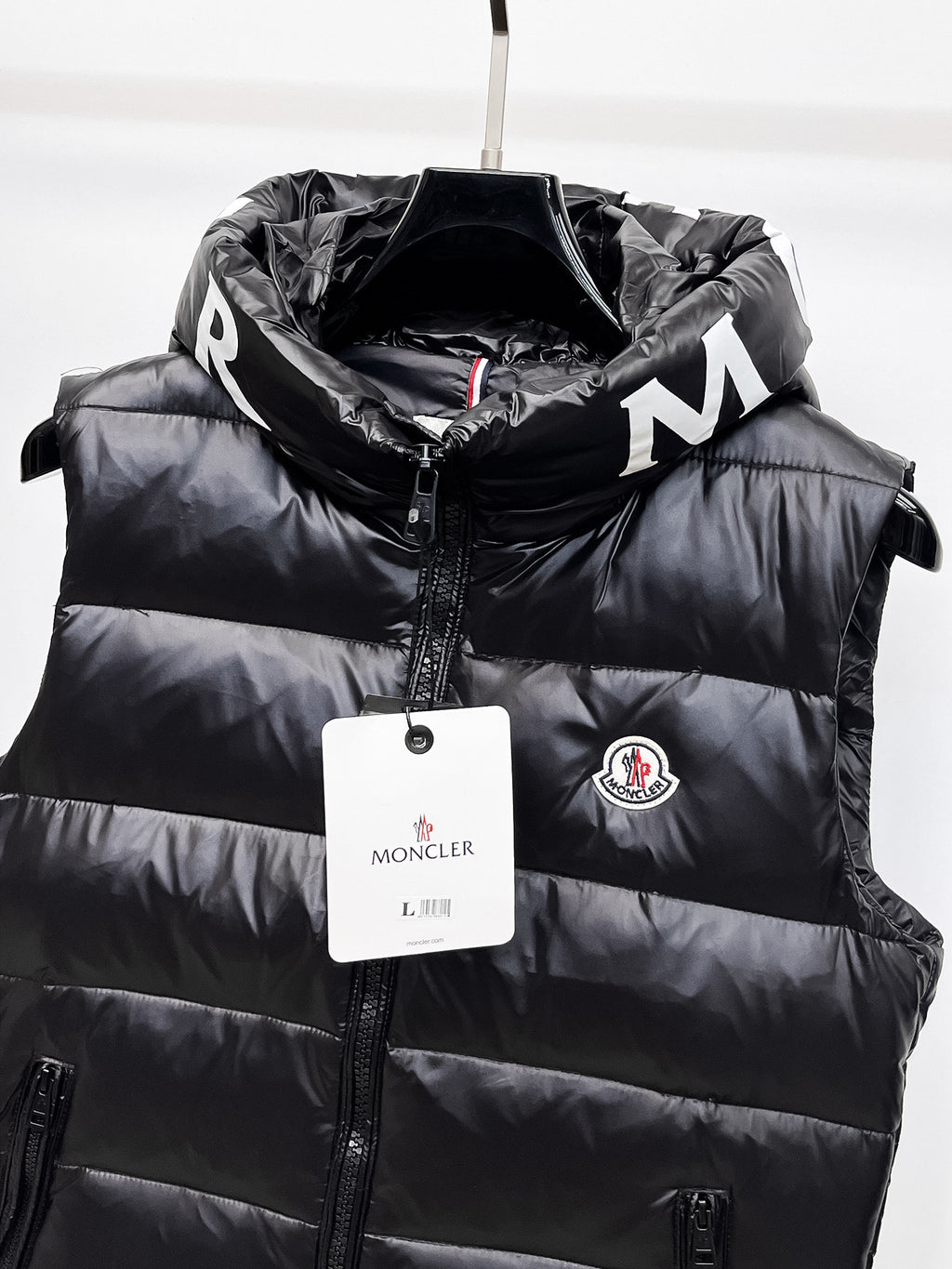 Moncler hooded puffer vest, black front panel with zipper and round Moncler badge