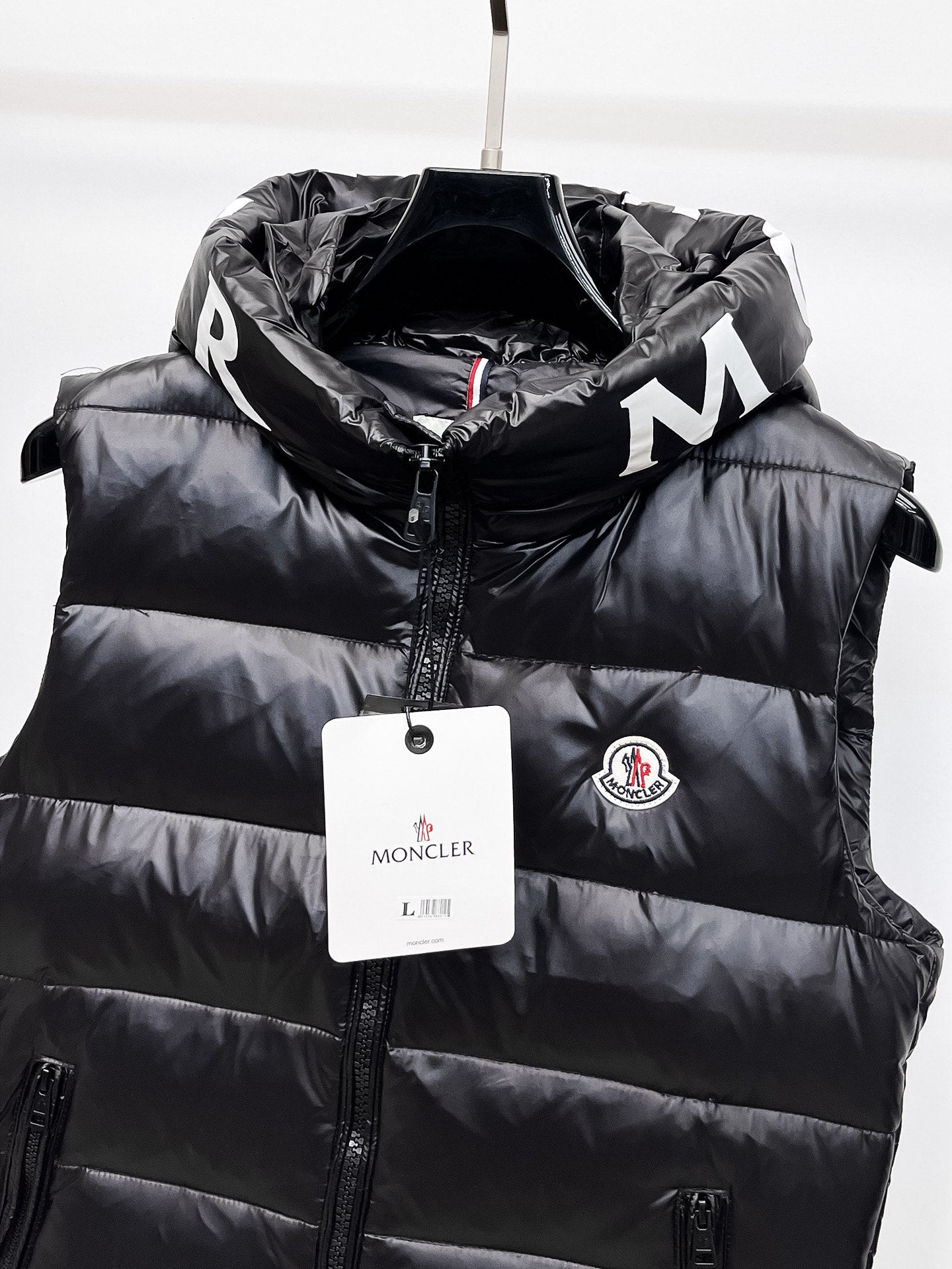 Moncler hooded puffer vest, black front panel with zipper and round Moncler badge
