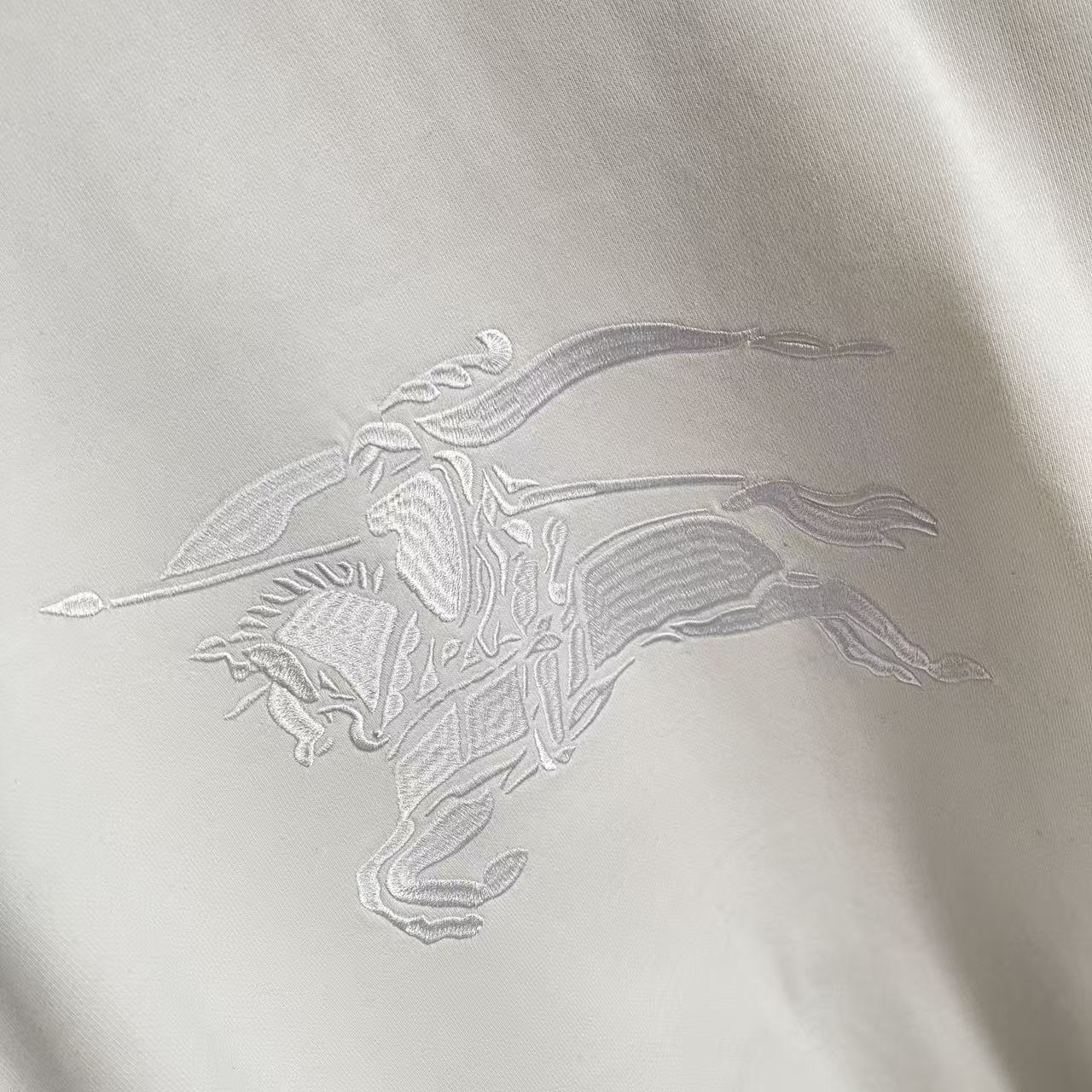 White embroidered horse graphic on Burberry sweatshirt front