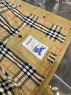 Plaid quilt lining with Burberry logo patch on quilted jacket front panel