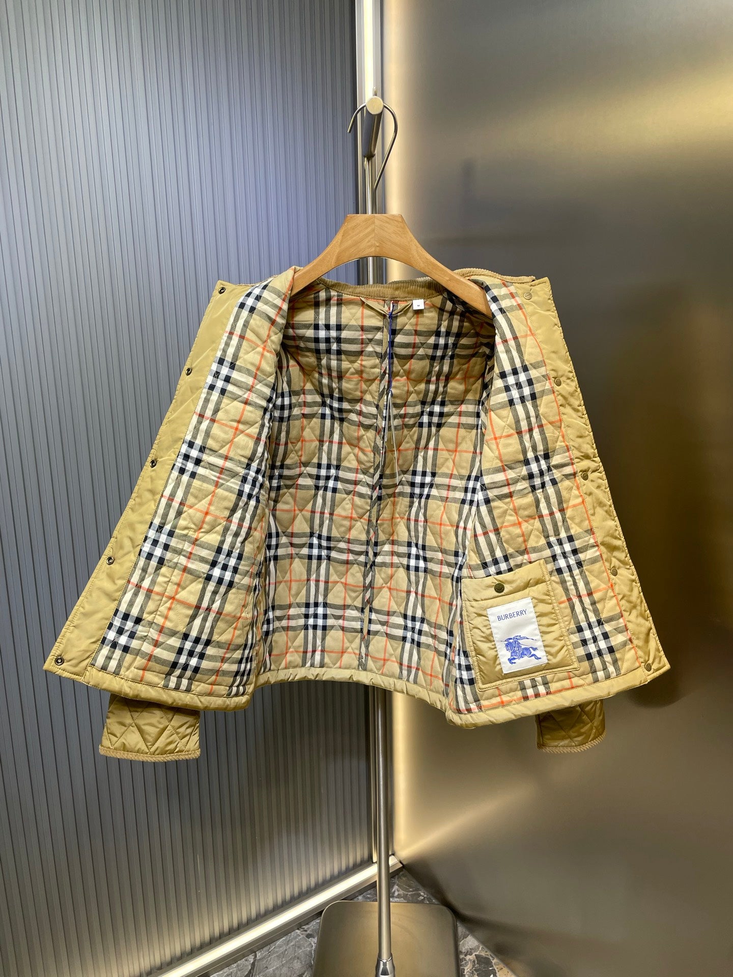 Kids quilted jacket in light yellow with plaid lining and buttoned front