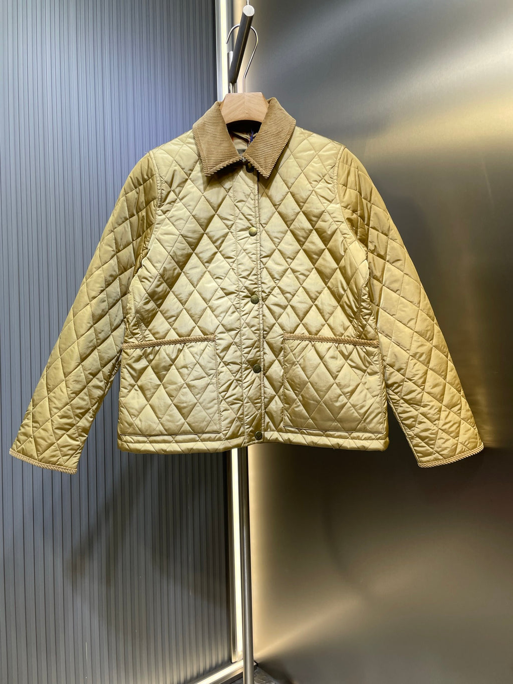 Quilted jacket with stand collar and button front in light yellow, long sleeves