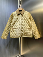 Quilted jacket with stand collar and button front in light yellow, long sleeves