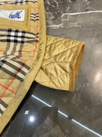 Plaid quilt lining with light yellow cuff and quilted shoulder detail, no visible front