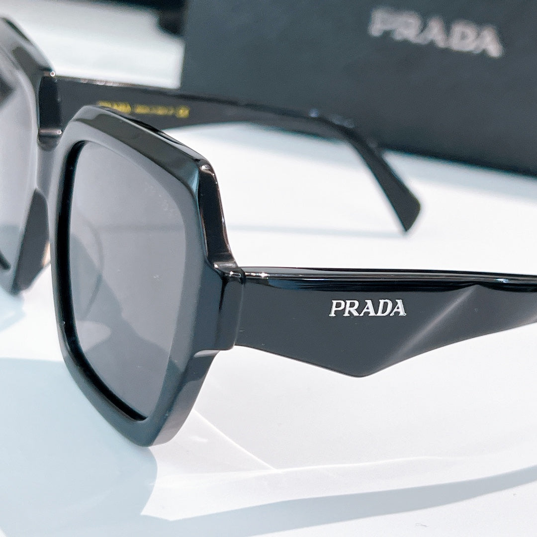 Prada sunglasses black angular frames with dark lenses, side view