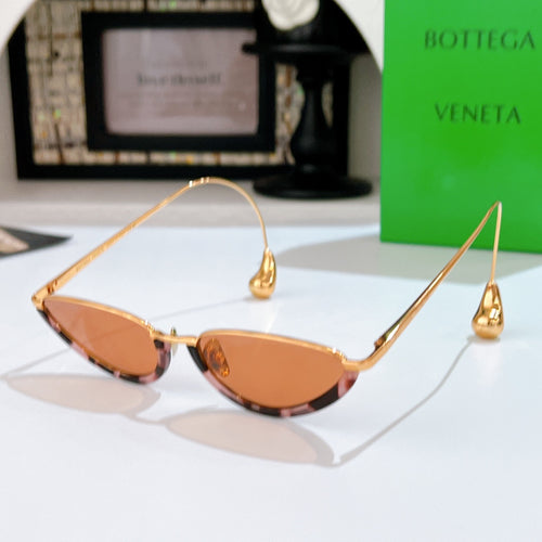 Bottega Veneta cat-eye sunglasses with gold frame and amber tinted lenses