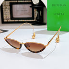 Bottega Veneta cat-eye sunglasses with gold frame and brown tinted lenses