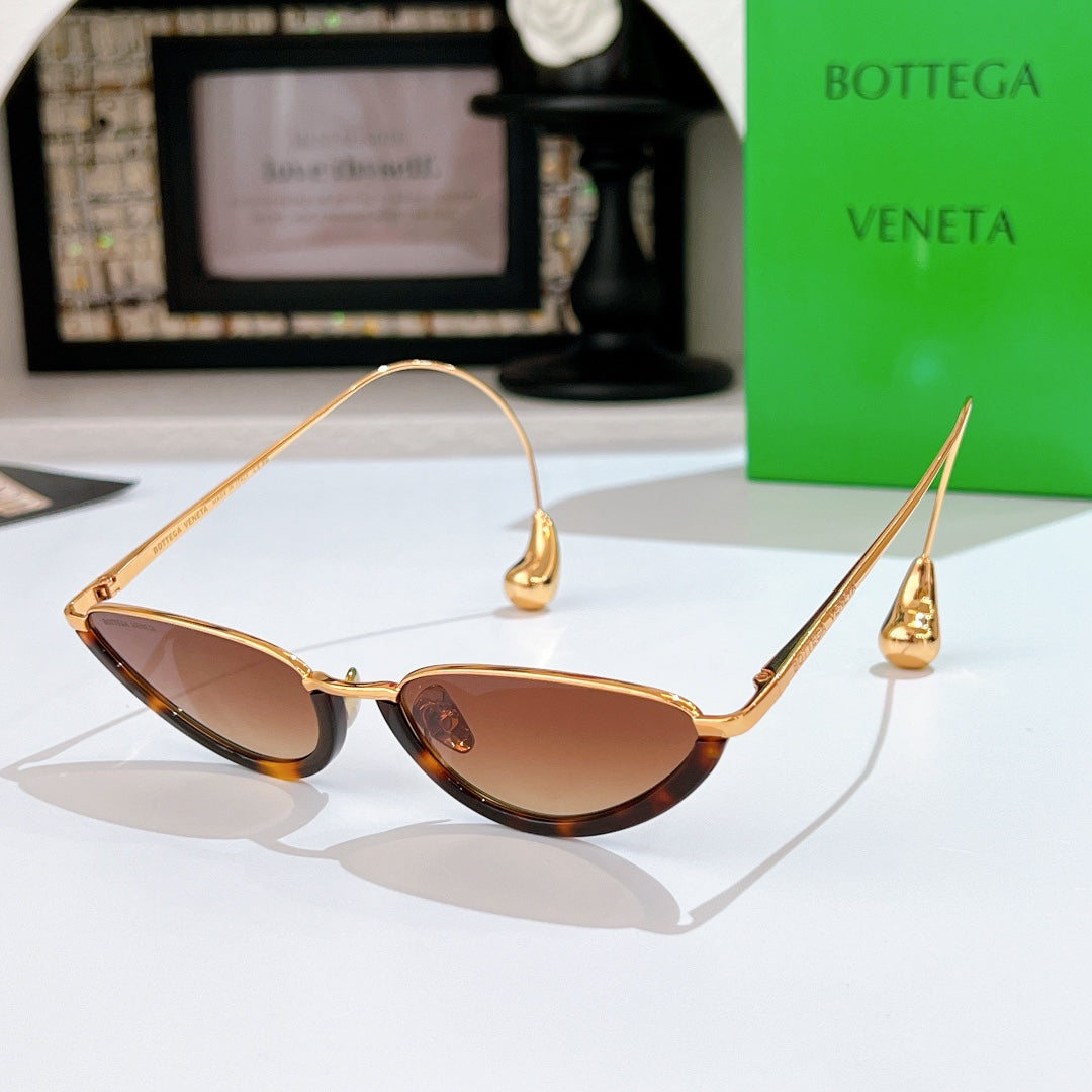 Bottega Veneta cat-eye sunglasses with gold frame and brown tinted lenses