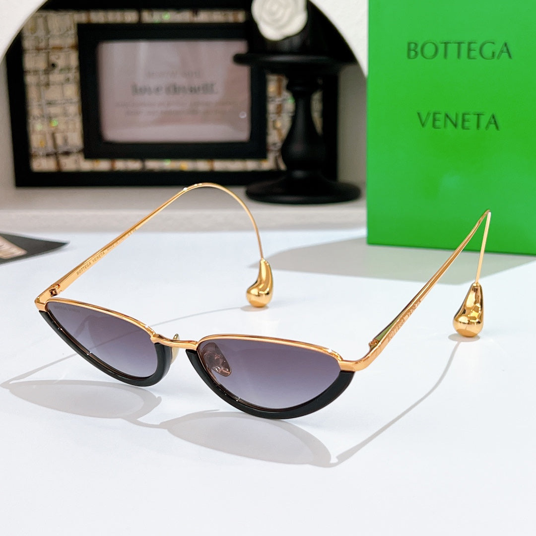 Bottega Veneta cat-eye sunglasses with gold frame and dark purple tinted lenses