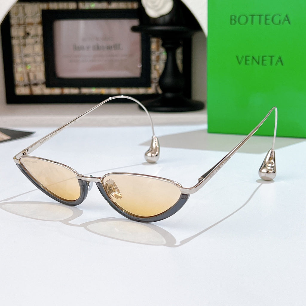 Bottega Veneta cat-eye sunglasses with silver frame and pale yellow tinted lenses