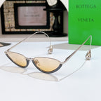 Bottega Veneta cat-eye sunglasses with silver frame and pale yellow tinted lenses
