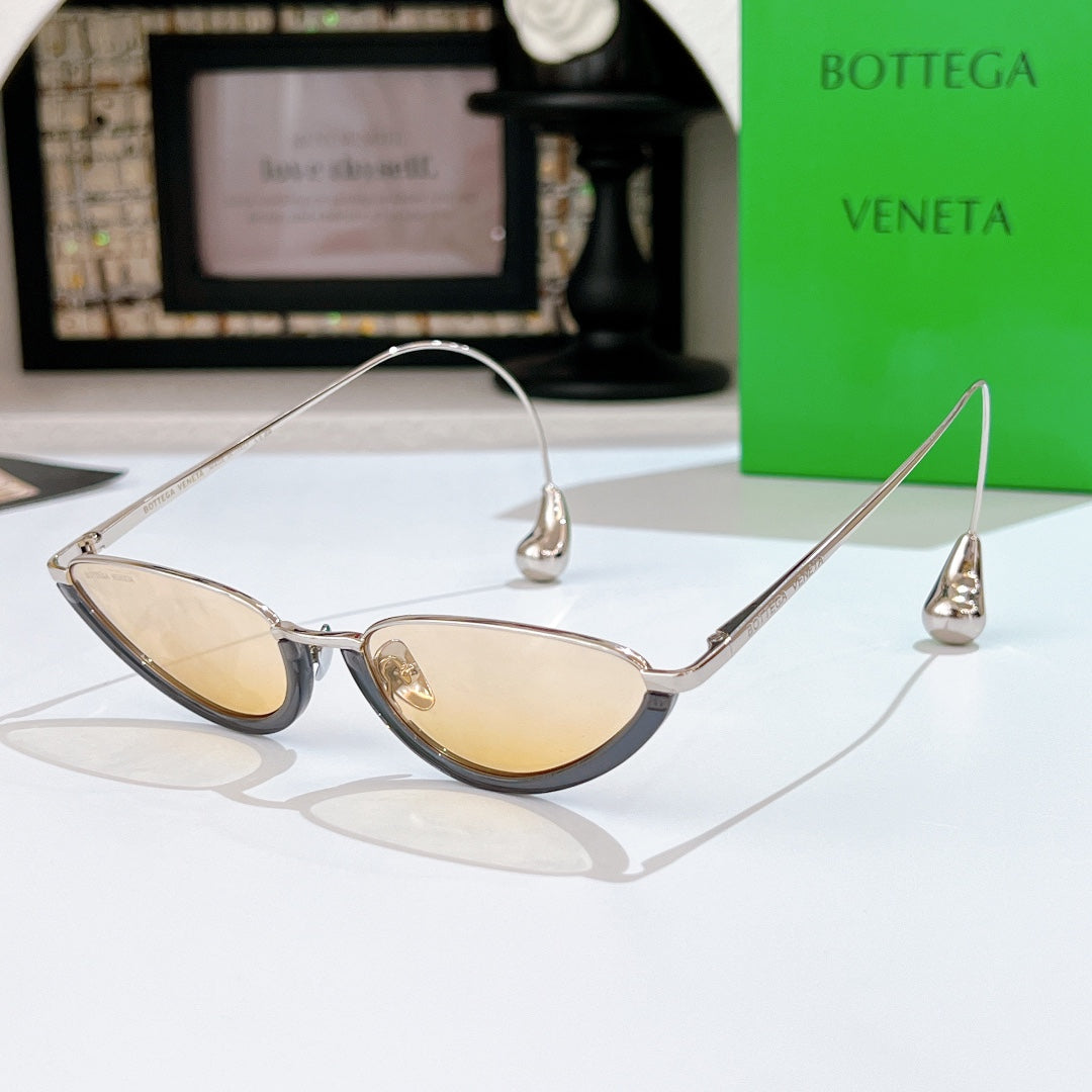 Bottega Veneta cat-eye sunglasses with silver frame and pale yellow tinted lenses