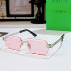 Bottega Veneta sunglasses with pink lenses, pale pink frame, black top bar, green temples