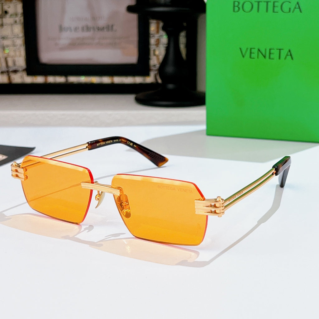 Bottega Veneta sunglasses with amber lenses, gold-tone frame, green accents on temples