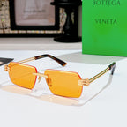 Bottega Veneta sunglasses with amber lenses, gold-tone frame, green accents on temples