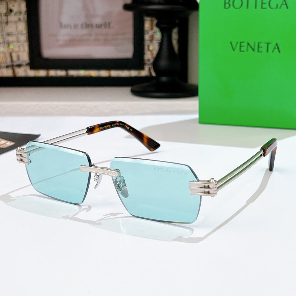 Bottega Veneta sunglasses with light blue lenses, silver frame, green accents on temples