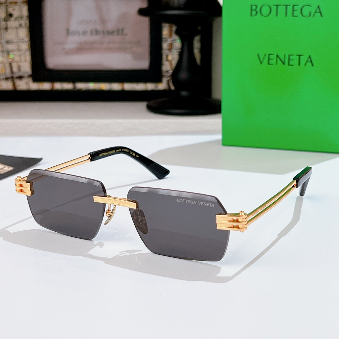 Bottega Veneta sunglasses with dark gray lenses, gold-tone frame, black top bar