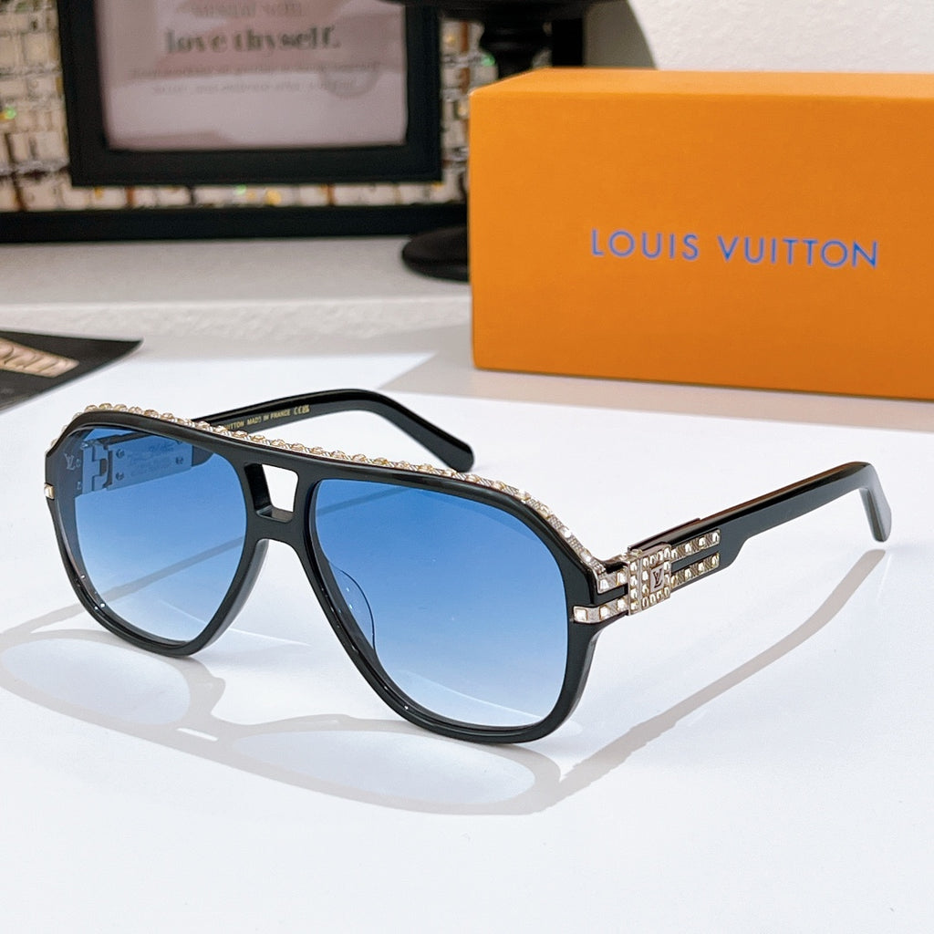 Sunglasses with blue frames and tinted lenses; rhinestone logo detail on temple band