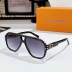 Sunglasses with black frames and tinted lenses; rhinestone logo detail on temple band