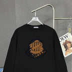 Black Moncler long-sleeve top with chest circular logo graphic and crew neck