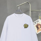 White long-sleeve sweatshirt close-up with Moncler smile logo patch