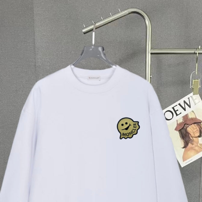 White long-sleeve sweatshirt close-up with Moncler smile logo patch