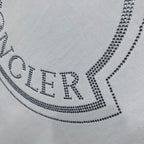 MONCLER wordmark on crest logo, dotted with crystal-like studs.