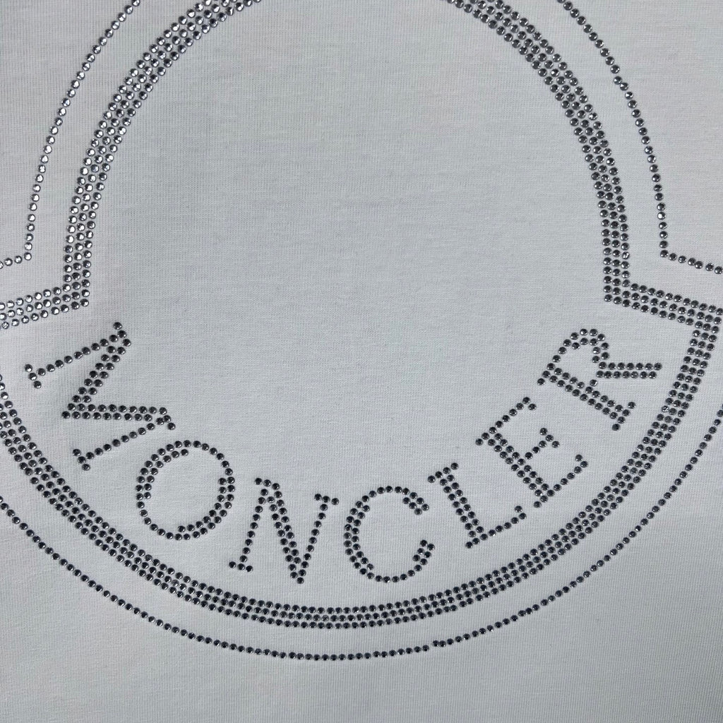 Moncler crest logo on white sweatshirt, dotted with crystal-like studs.