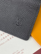 Black textured leather small bag with embossed LV logo on front panel.