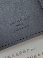 Black textured leather small bag with embossed Louis Vuitton Paris logo.