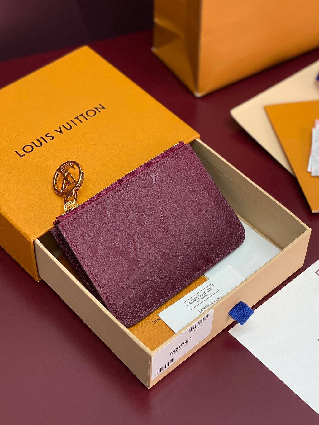 Small leather pouch bag with burgundy monogram and gold-tone keyring clasp